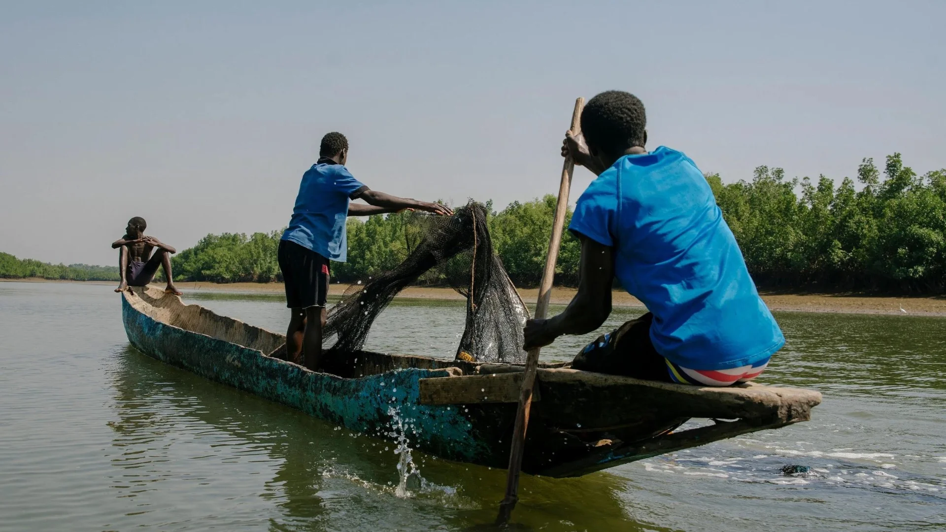 Fishing boats in a West African coastal community illustrating the dependence of local livelihoods on healthy aquatic ecosystems
