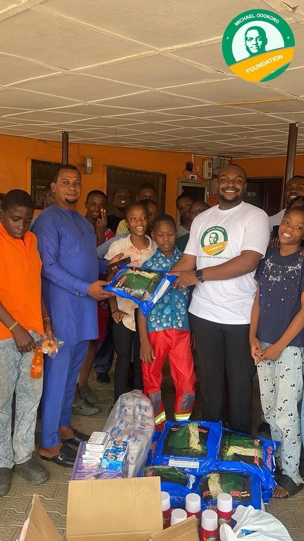Michael Odokoro, founder of the Michael Odokoro Foundation, hands out malaria-treated mosquito nets during his visit.