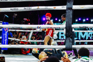 Phyna after knocking Nkechi Blessing (on the canvas) out in the fourth round at “Chaos in the Ring” in Lagos. Photo by Oluwabukunmi Fakanbi