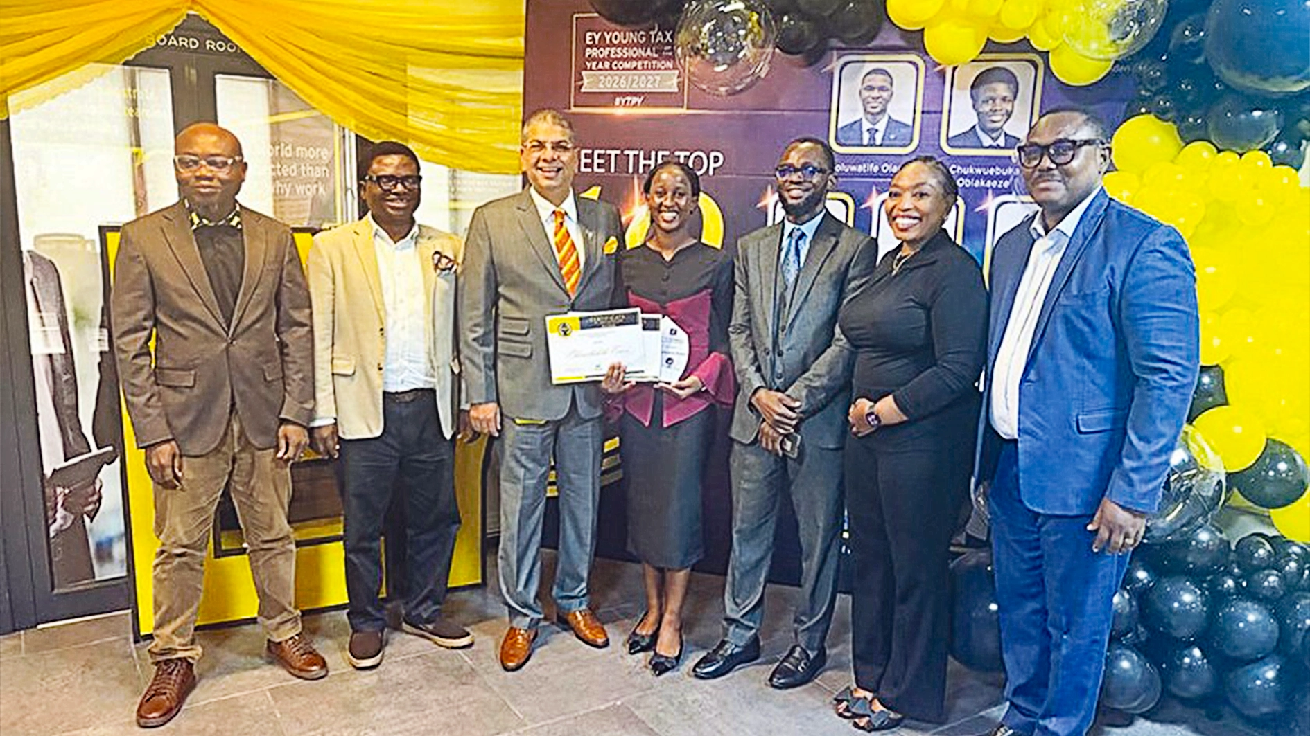 Winner of the 2025 EY Young Tax Professional of the Year, Oluwabukola Essien (middle) with EY partners at the ceremony in Lagos, recently.