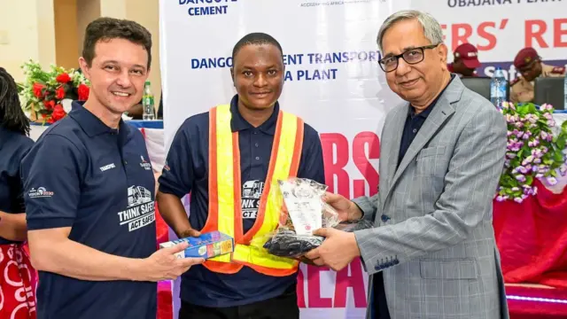 Head of Transport, Dangote Cement Plc, Mr. Murilo Silva(L) and the Group Managing Director, DCP, Arvind Pathak(R), present an award to one of the company’s drivers at the Drivers Safety Retreat at the Obajana Plant